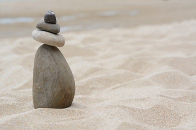 Photo of Stackstones on beautiful sandy beach, space for text