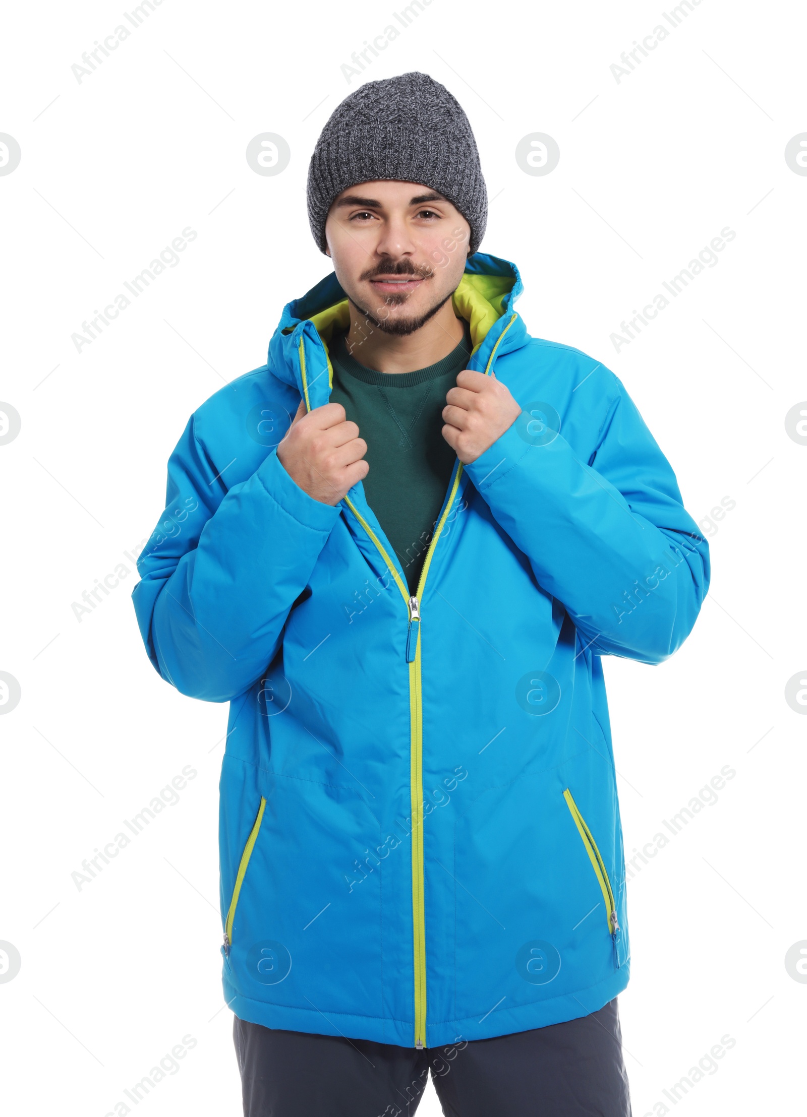 Photo of Young man wearing warm clothes on white background. Ready for winter vacation