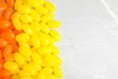 Flat lay composition with jelly beans on light background, closeup. Space for text