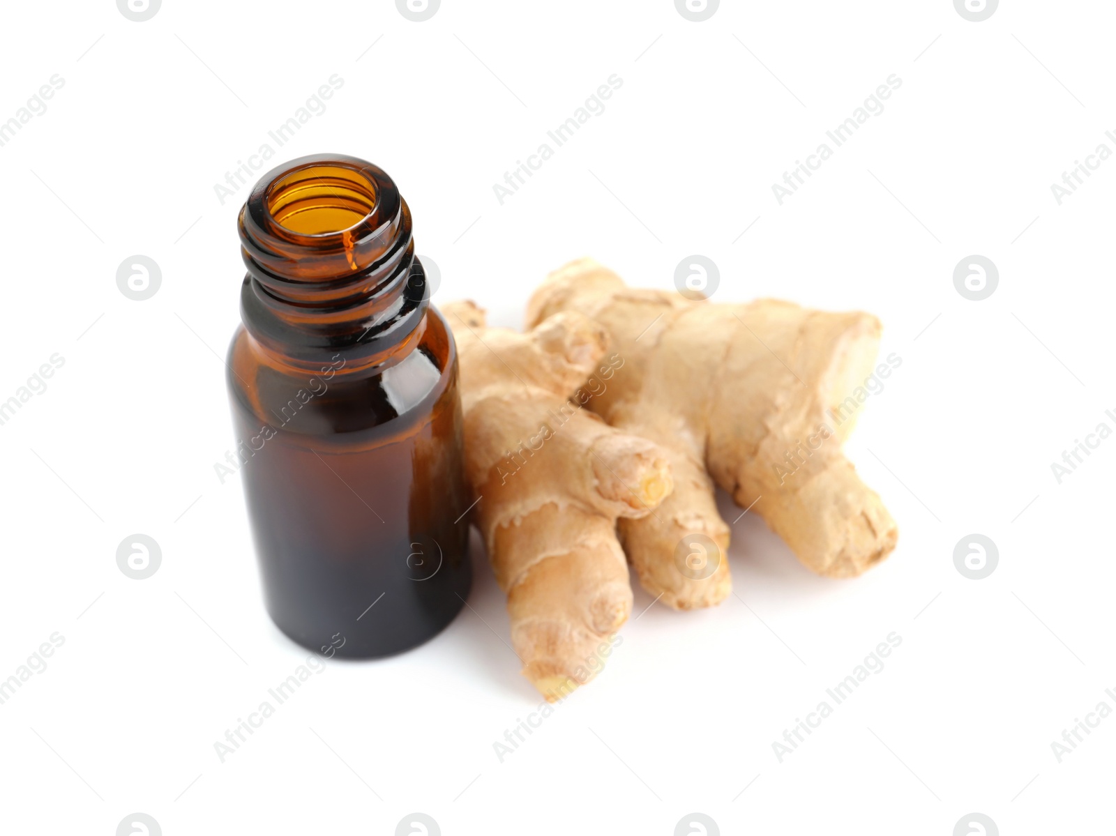 Photo of Glass bottle of essential oil and ginger root on white background