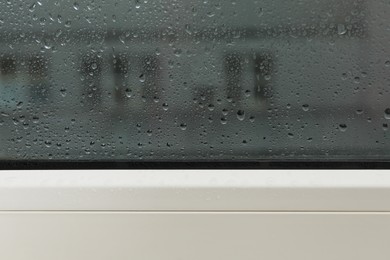 Window glass with water drops, closeup. Rainy weather