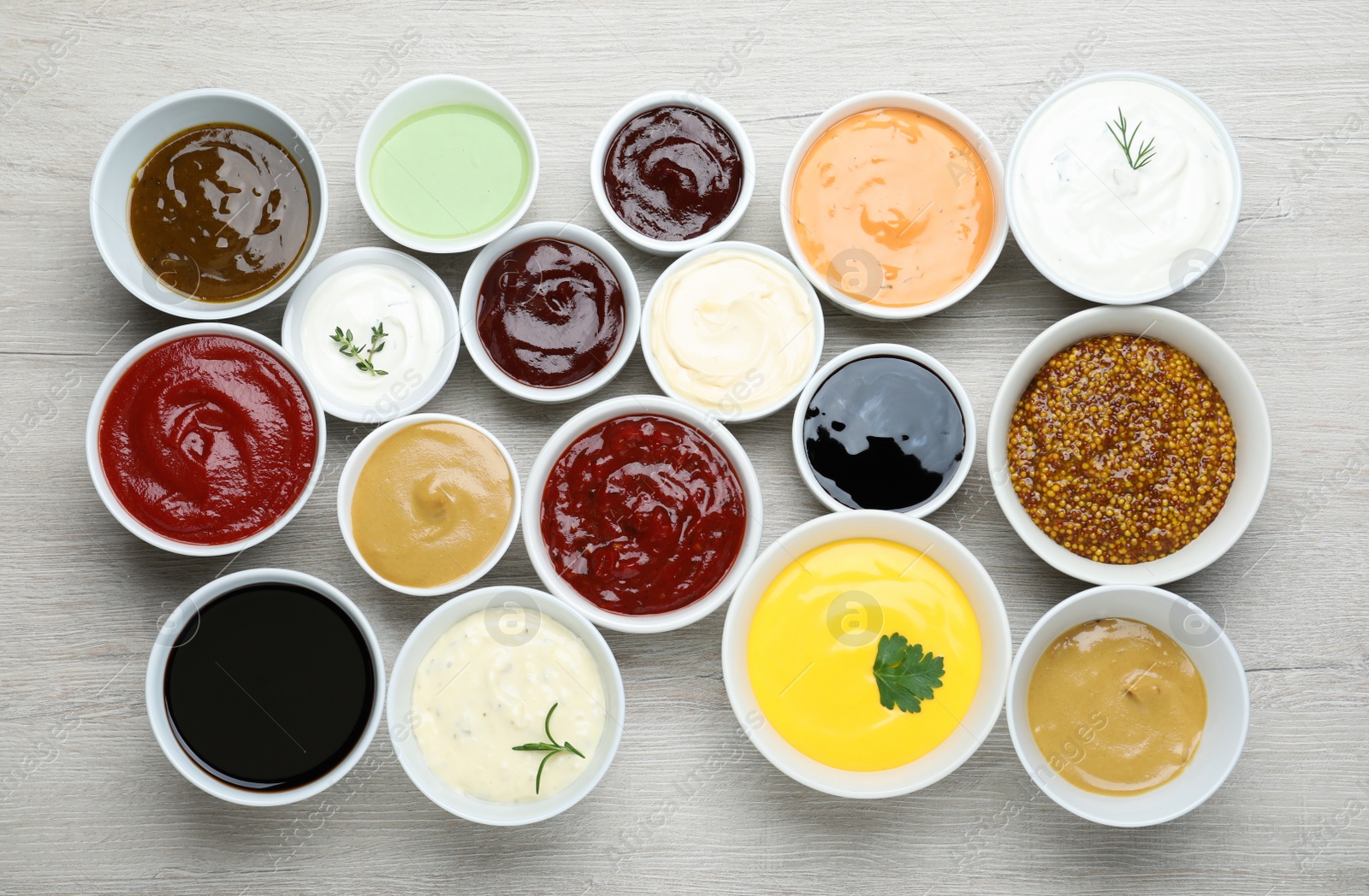 Photo of Many different sauces on white wooden table, flat lay