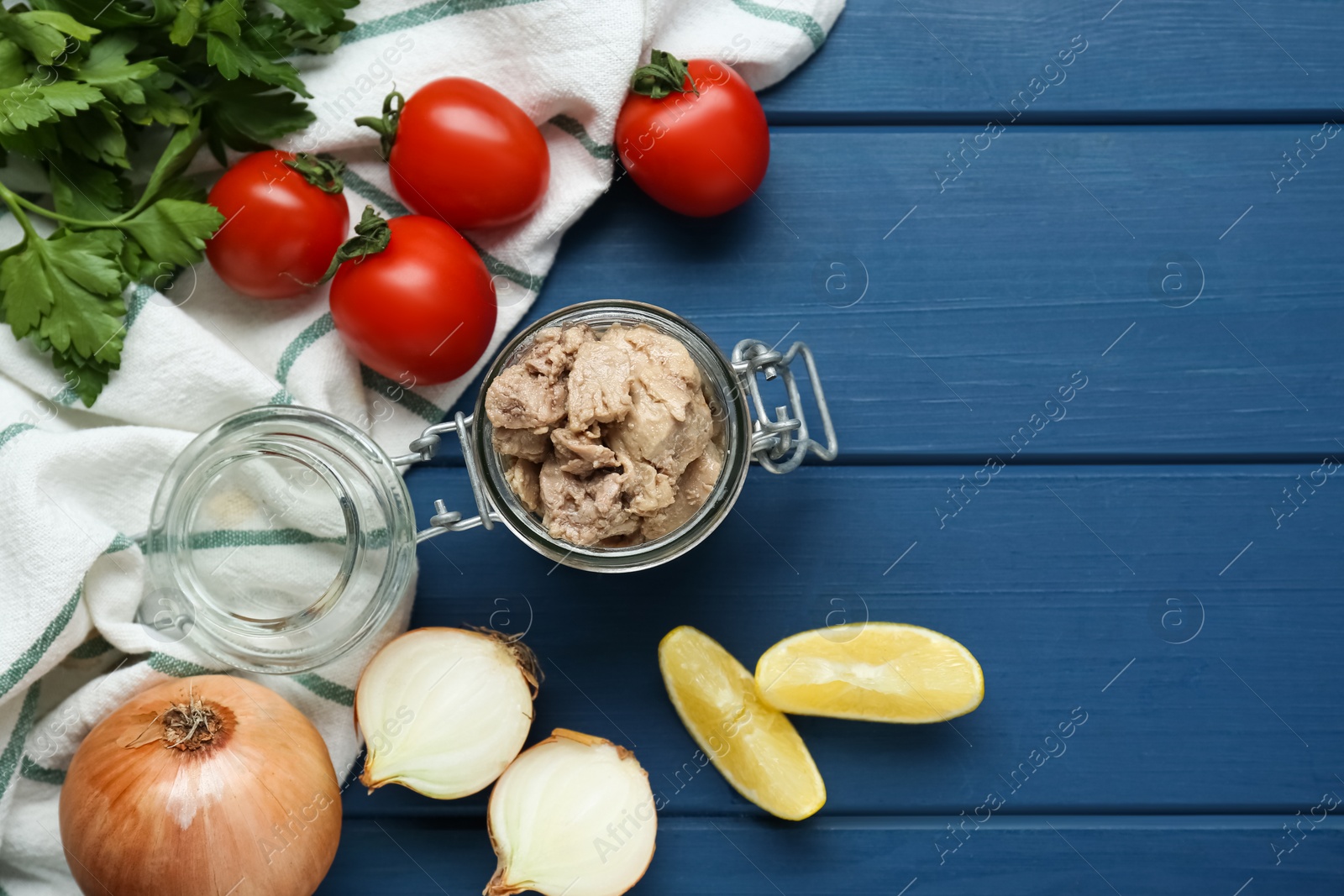 Photo of Flat lay composition with tasty cod liver and different products on blue wooden table. Space for text