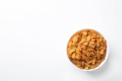 Bowl with raisins and space for text on white background, top view. Dried fruit as healthy snack