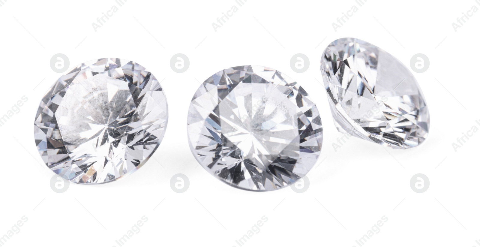 Photo of Three beautiful shiny diamonds isolated on white