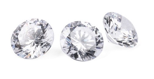 Photo of Three beautiful shiny diamonds isolated on white