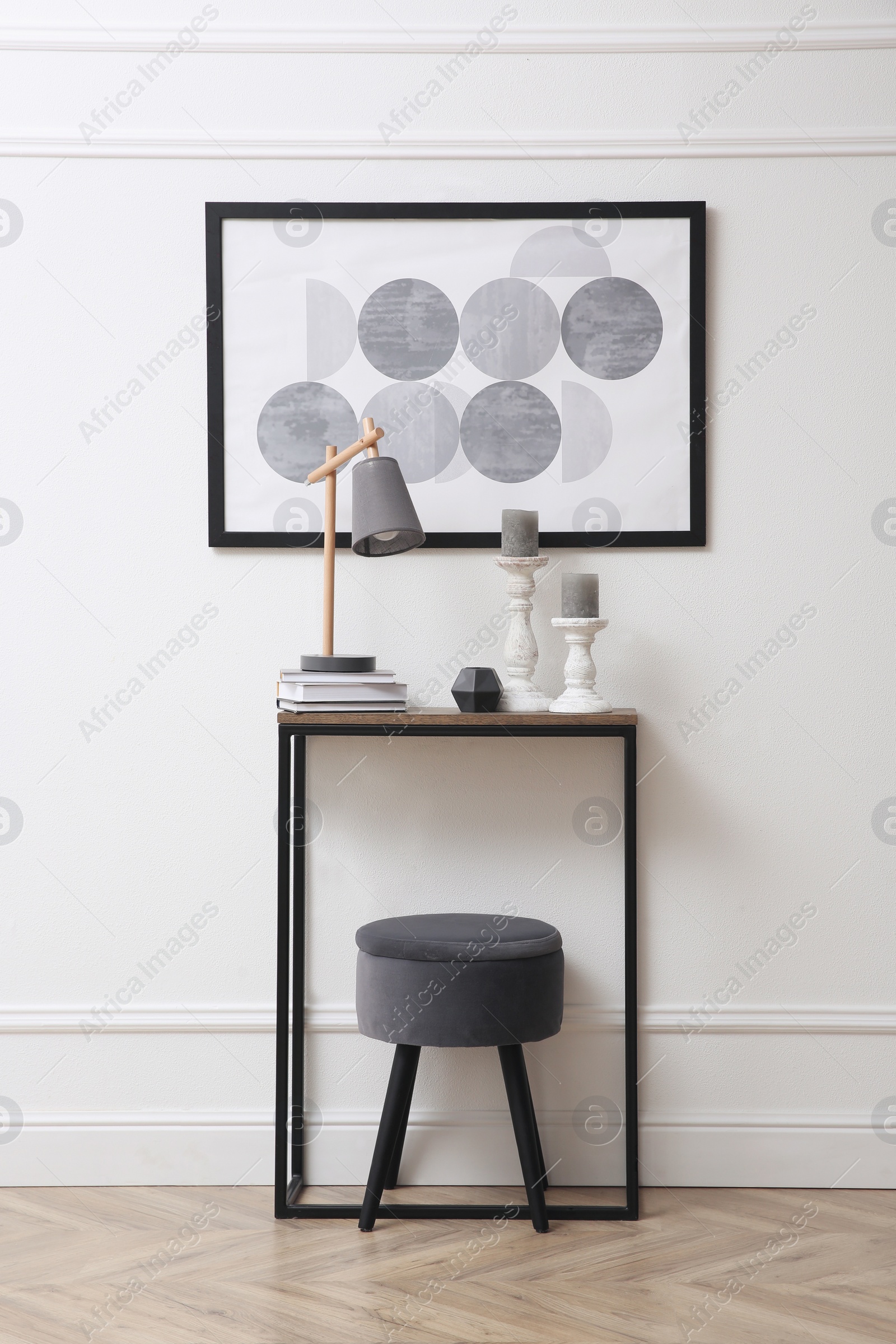 Photo of Hallway with stylish console table and picture. Interior design