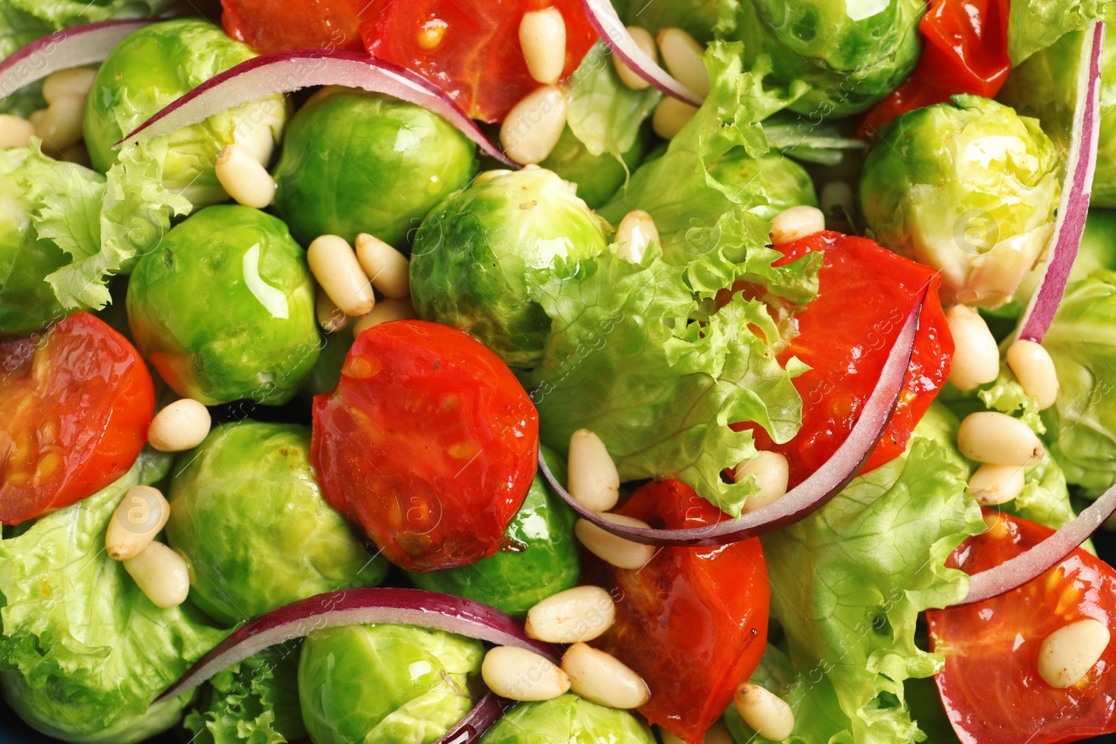 Photo of Salad with Brussels sprouts and pine nuts as background, closeup