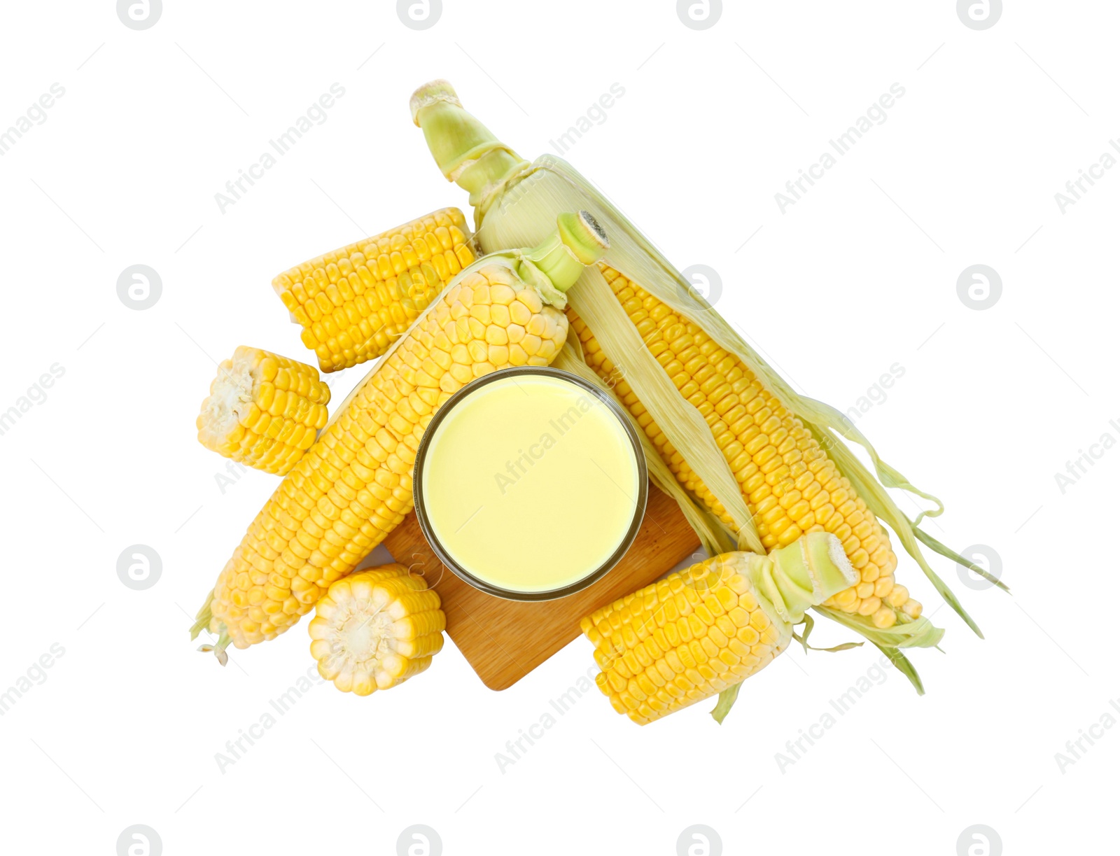 Photo of Tasty fresh corn milk in glass and cobs on white background, top view