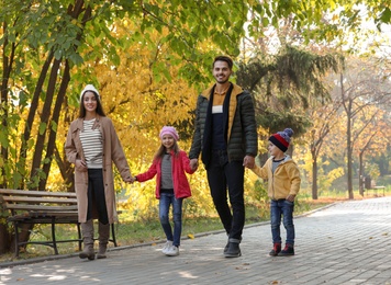 Photo of Happy family with children spending time together in park. Autumn walk