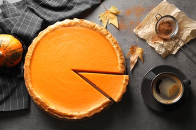 Photo of Flat lay composition with fresh delicious homemade pumpkin pie on table