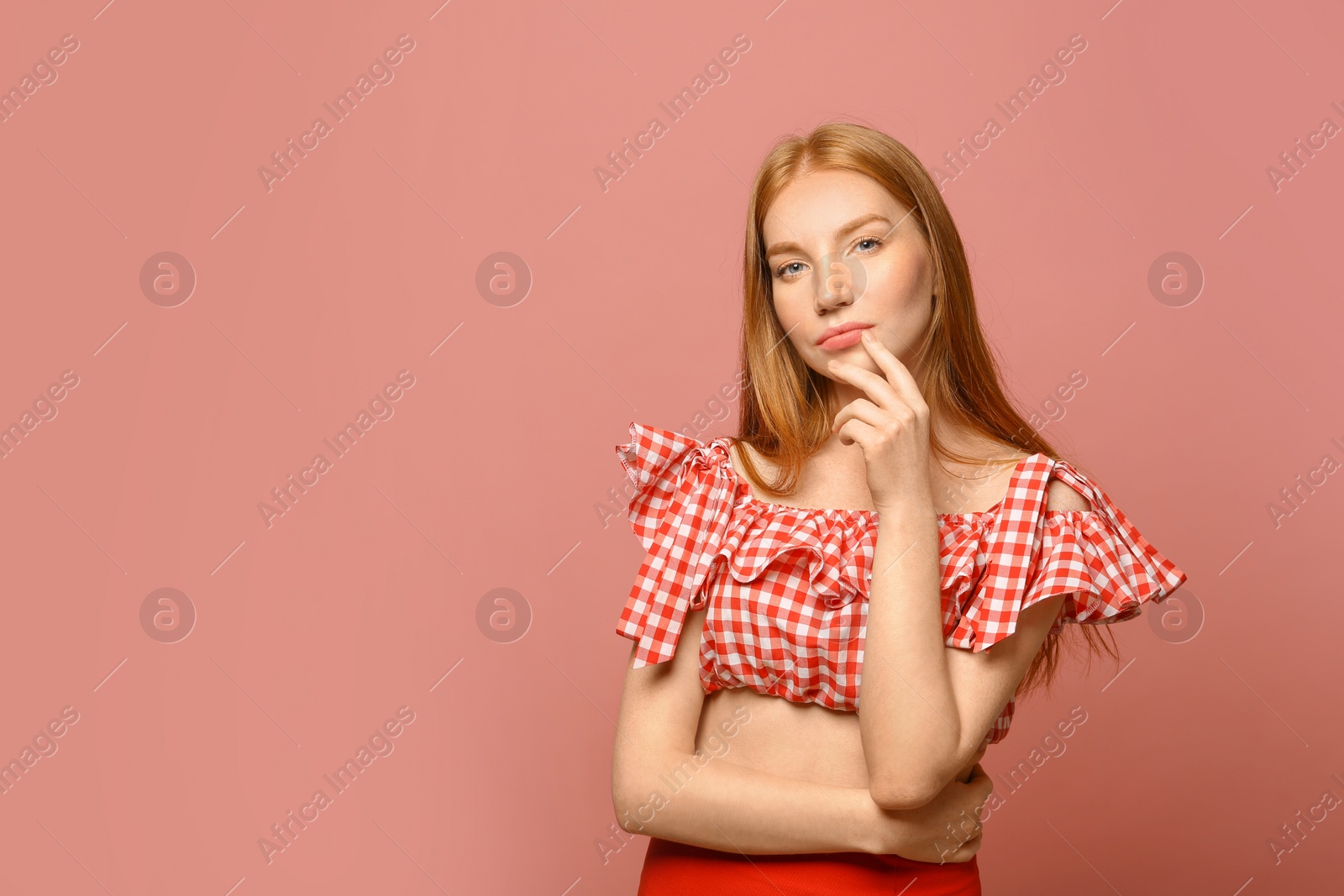 Photo of Portrait of beautiful young woman on pink background, space for text