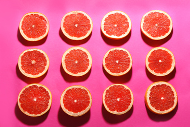 Flat lay composition with tasty ripe grapefruit slices on magenta background