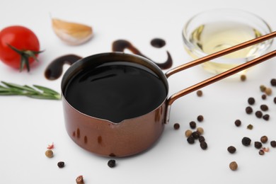 Photo of Organic balsamic vinegar and cooking ingredients on white background