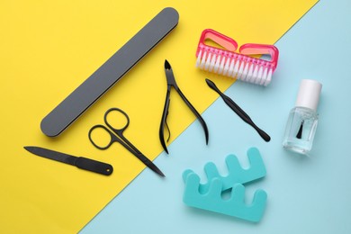 Photo of Set of pedicure tools on color background, flat lay