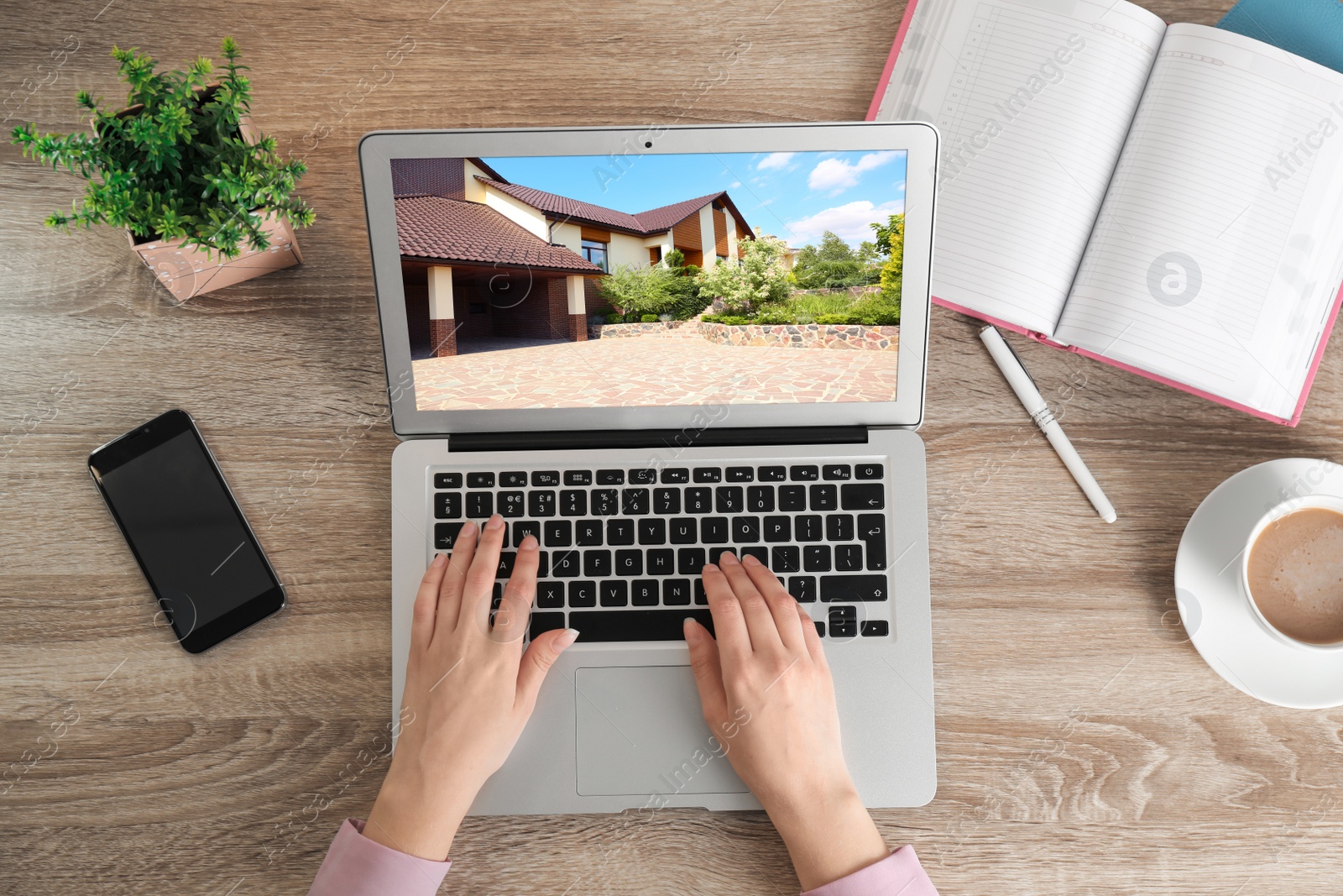 Image of Woman choosing new house online using laptop or real estate agent working at table, top view