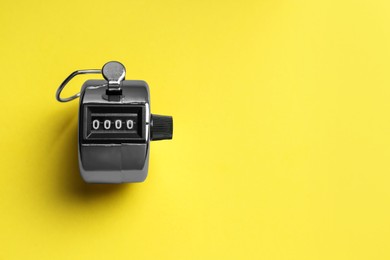 Photo of Modern timer on yellow background, top view. Space for text