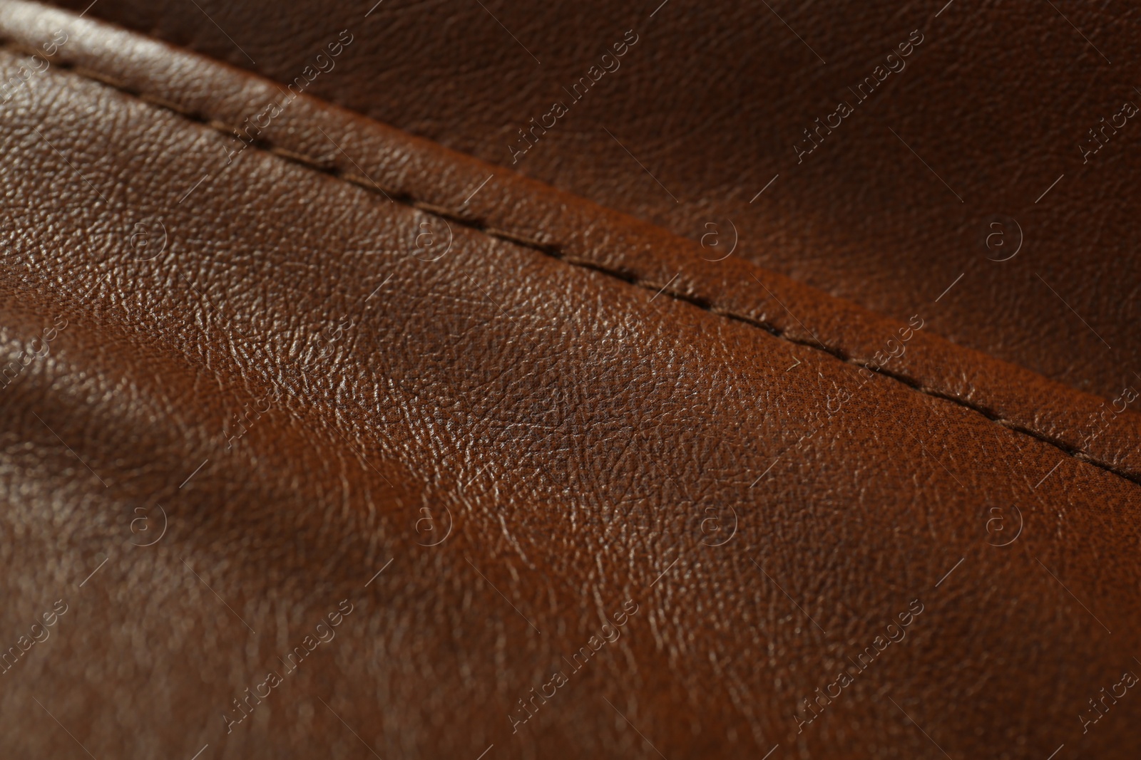 Photo of Brown leather with seam as background, above view