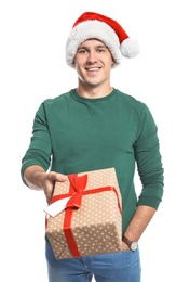 Photo of Young man with Christmas gift on white background