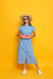 Photo of Beautiful girl with slice of watermelon on yellow background