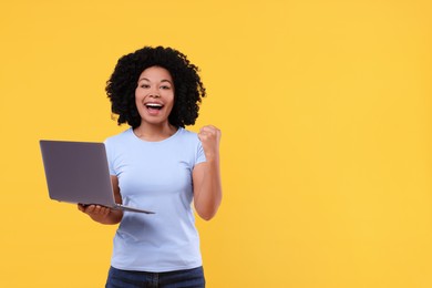Photo of Emotional young woman with laptop on yellow background. Space for text