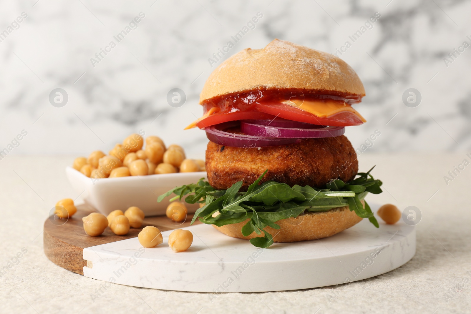Photo of Tasty vegetarian burger with chickpea cutlet on white table