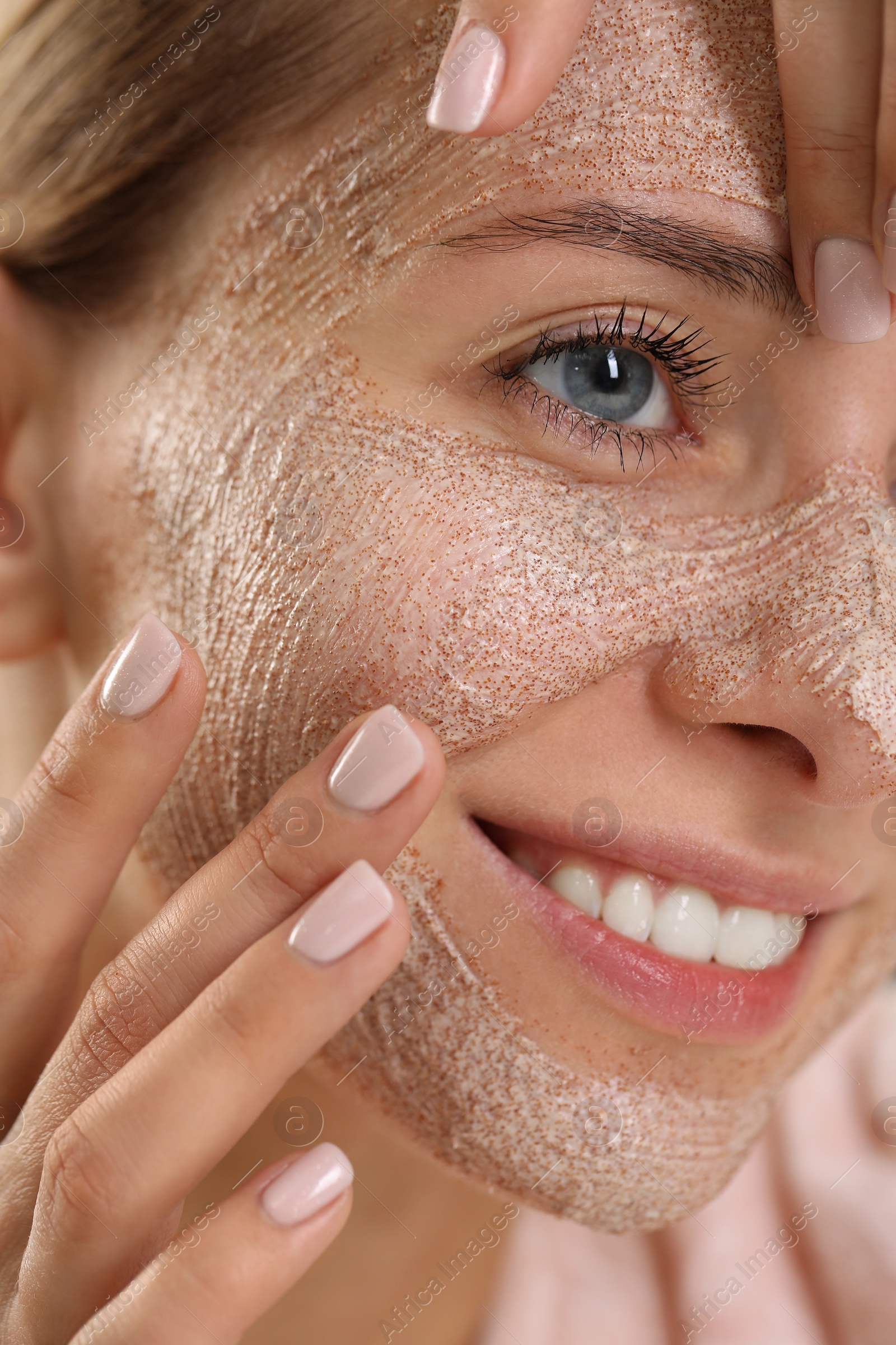 Photo of Woman applying face mask, closeup. Spa treatments