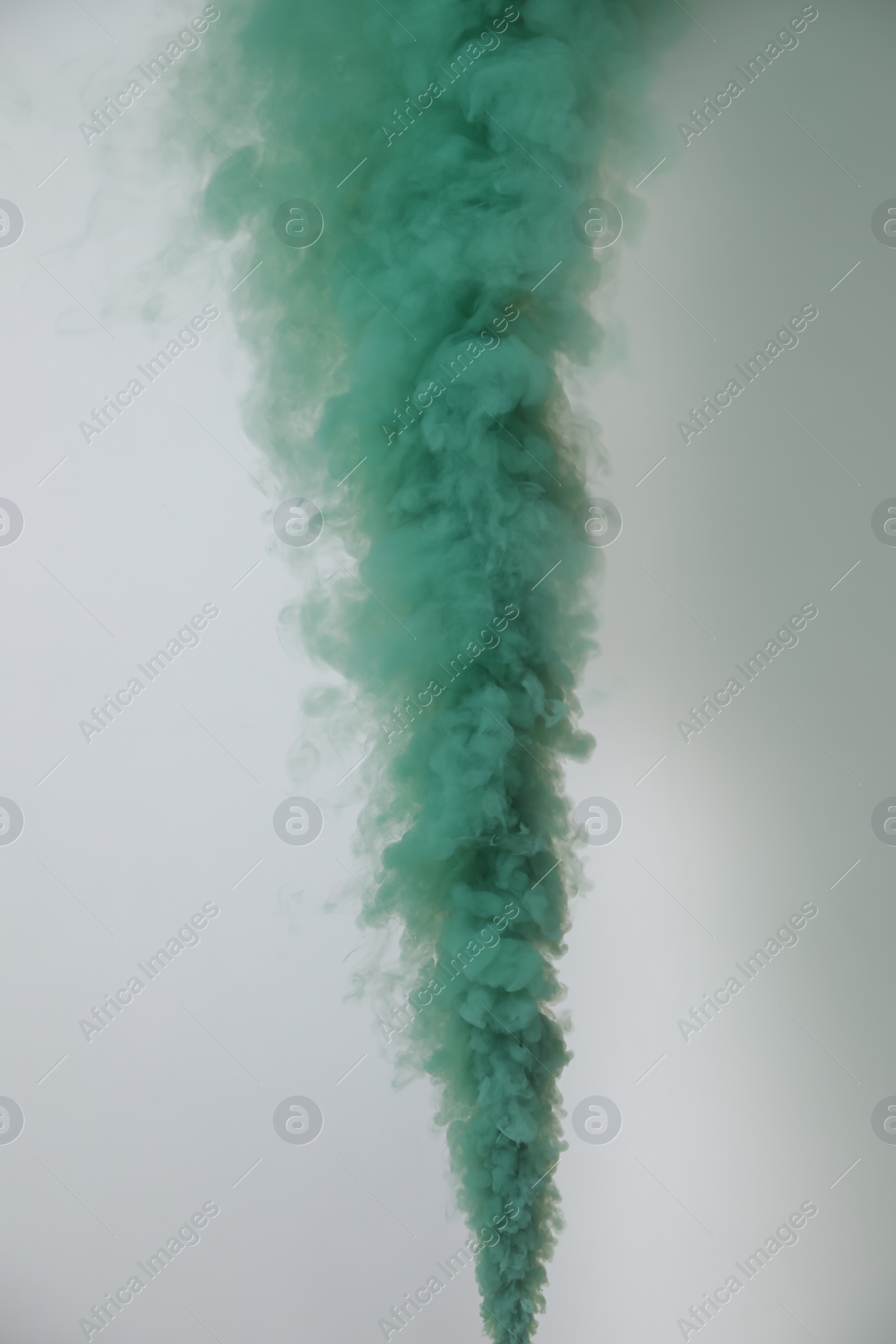 Photo of Bright green smoke bomb on white background