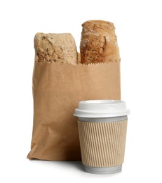 Photo of Paper bag with bread and cup of coffee on white background. Space for design