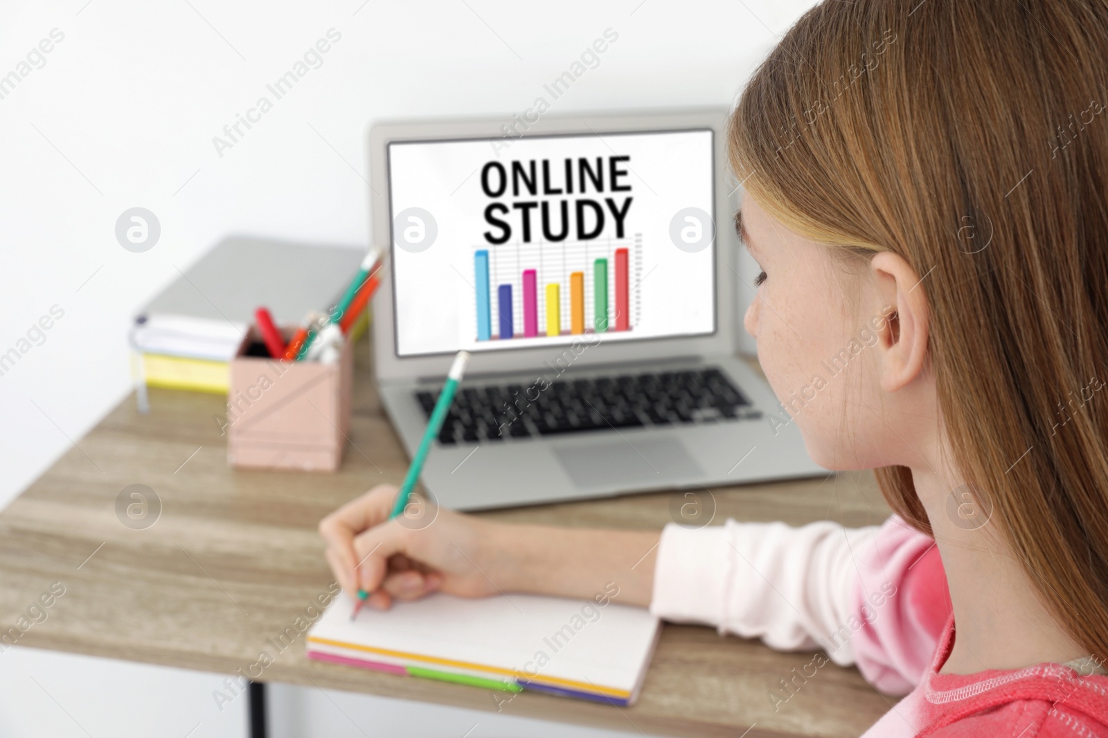 Image of Teenager girl using laptop for online studying at home, closeup