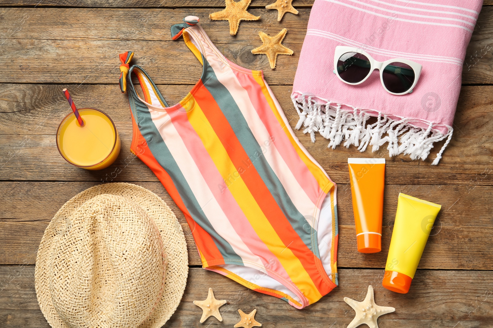 Photo of Flat lay composition with beach accessories on wooden background