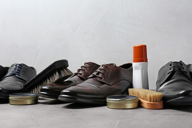 Photo of Footwear and shoe shine kit on grey surface