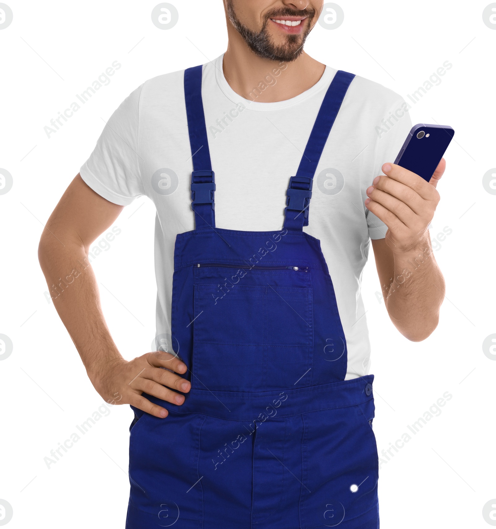 Photo of Professional repairman in uniform with phone on white background, closeup