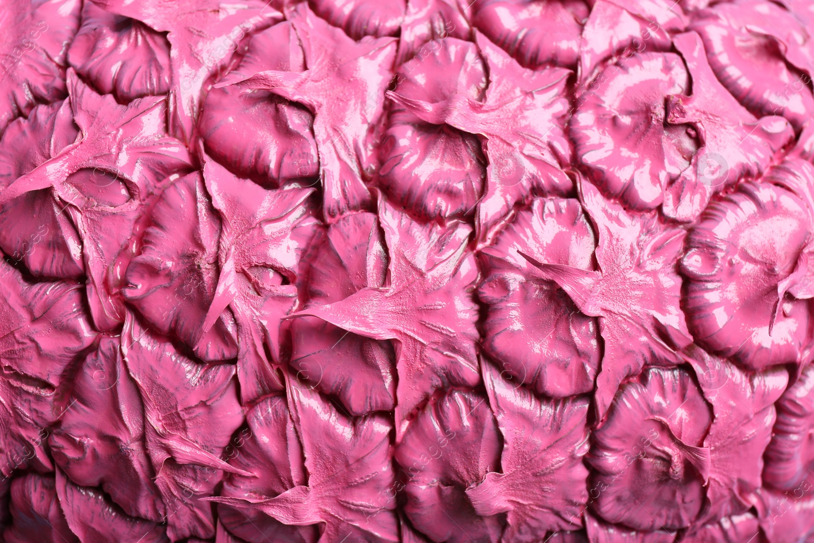 Photo of Pink pineapple as background, closeup. Creative concept