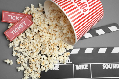 Flat lay composition with popcorn and cinema tickets on grey background