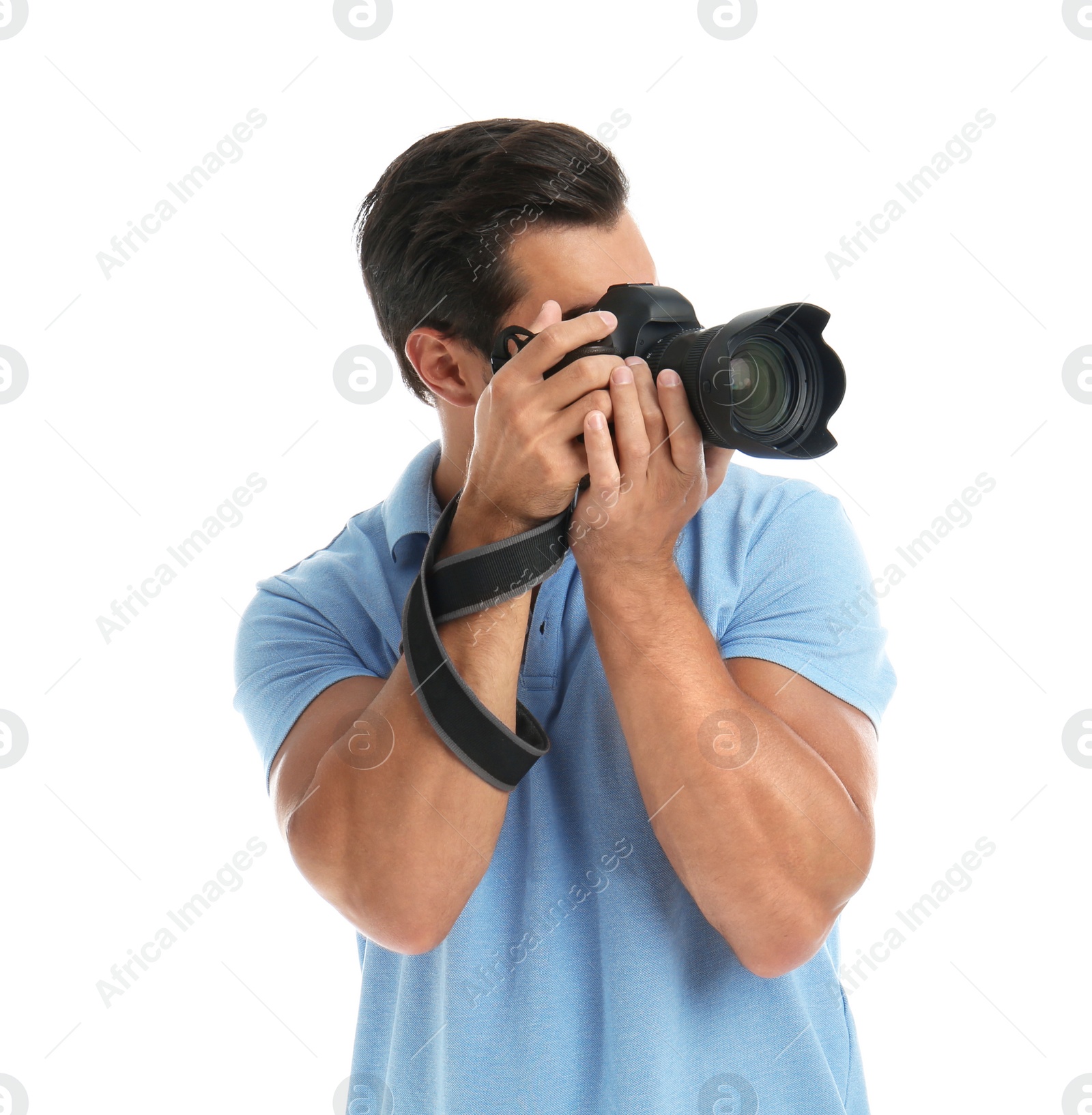 Photo of Young professional photographer taking picture on white background