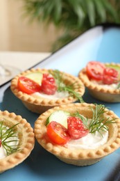 Photo of Delicious canapes with dry smoked sausages, cream cheese and vegetables on table, closeup