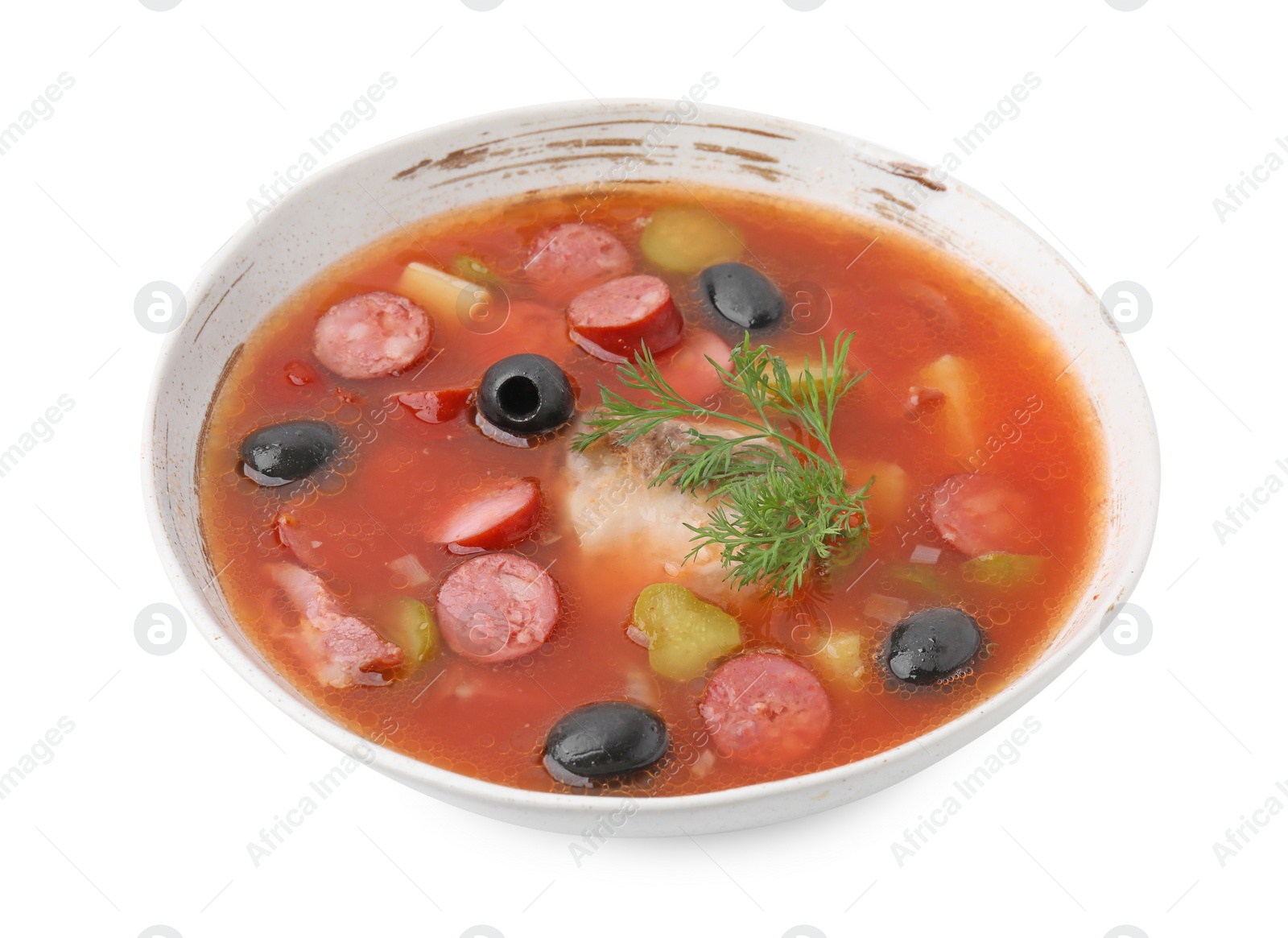 Photo of Meat solyanka soup with thin dry smoked sausages in bowl isolated on white