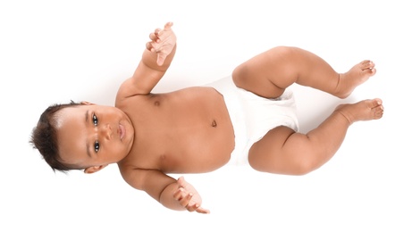 Adorable African-American baby in diaper on white background, top view