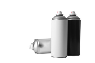 Photo of Cans of different spray paints on white background