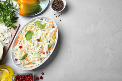 Fresh cabbage salad served on light grey table, flat lay. Space for text