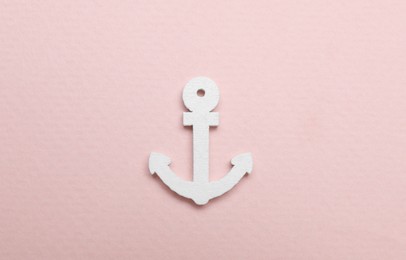Photo of Anchor figure on pale pink background, top view