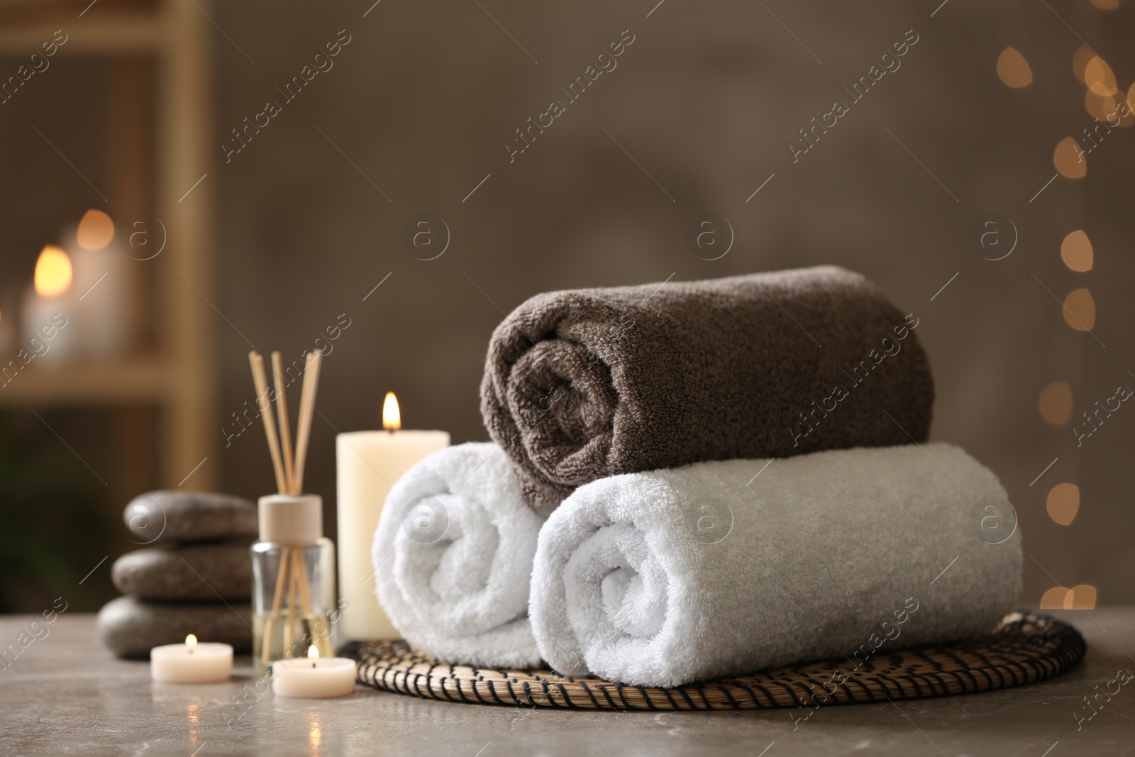 Photo of Beautiful composition with spa stones on grey marble table