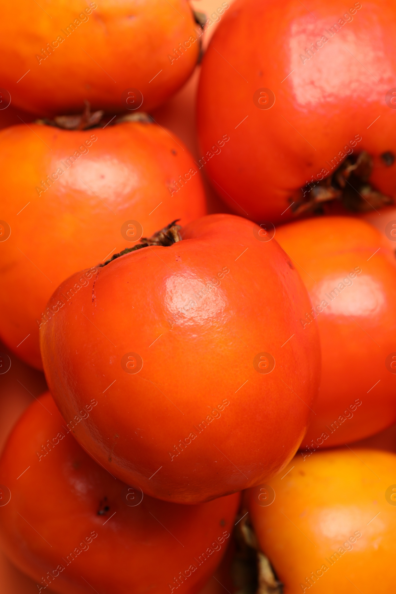 Photo of Delicious ripe juicy persimmons as background, closeup