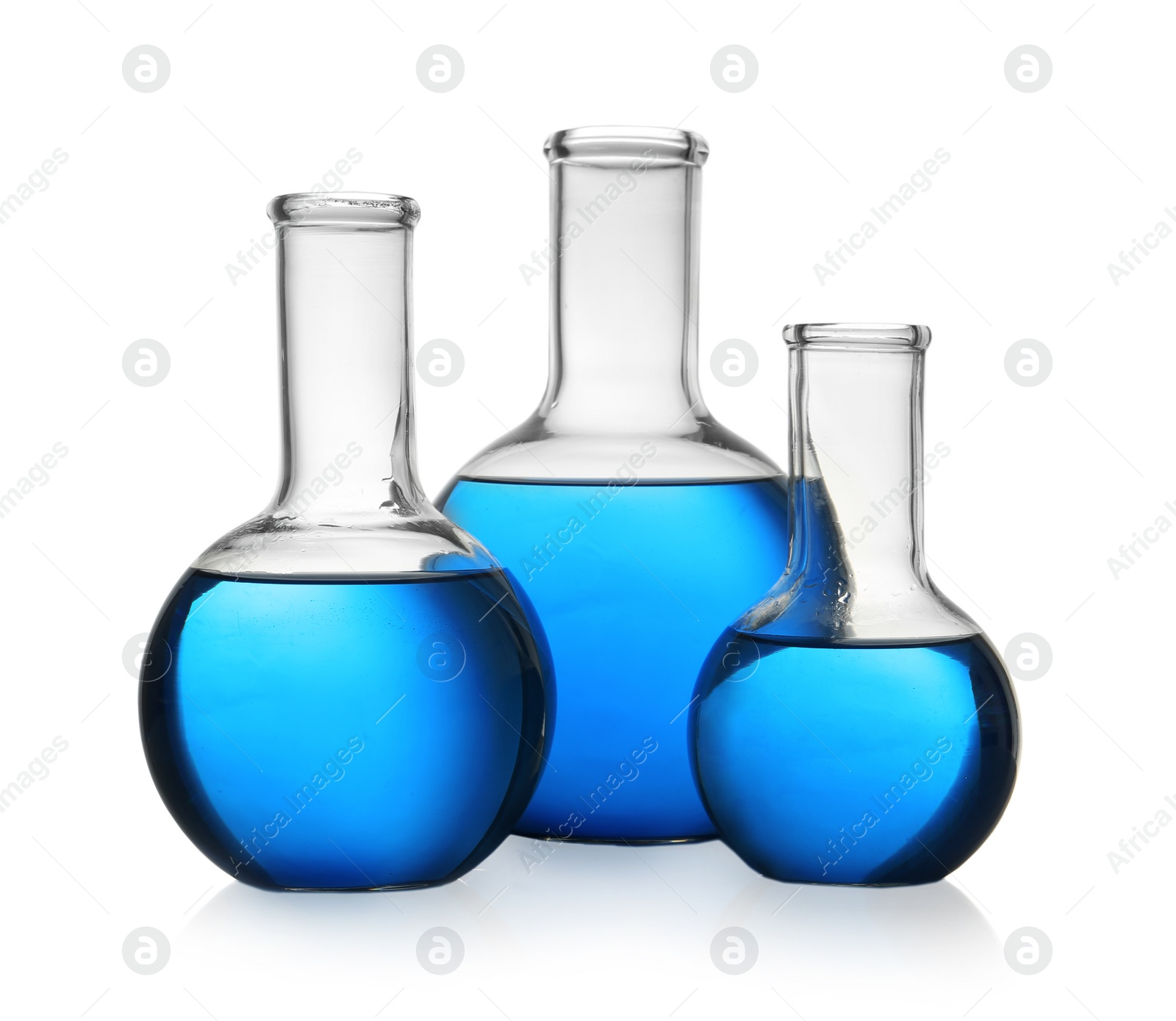 Photo of Florence flasks with blue liquid on white background. Laboratory glassware