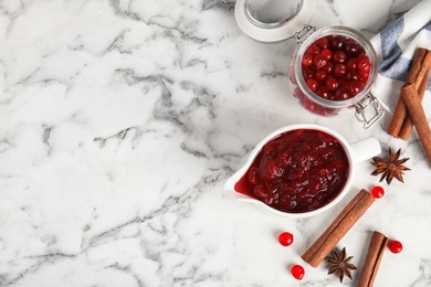 Photo of Flat lay composition with cranberry sauce on marble background. Space for text