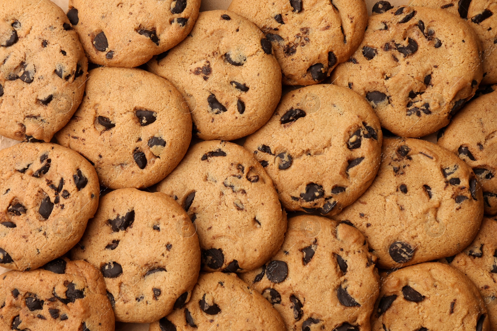 Photo of Delicious chocolate chip cookies as background, top view