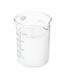 Photo of Fresh milk in measuring cup isolated on white