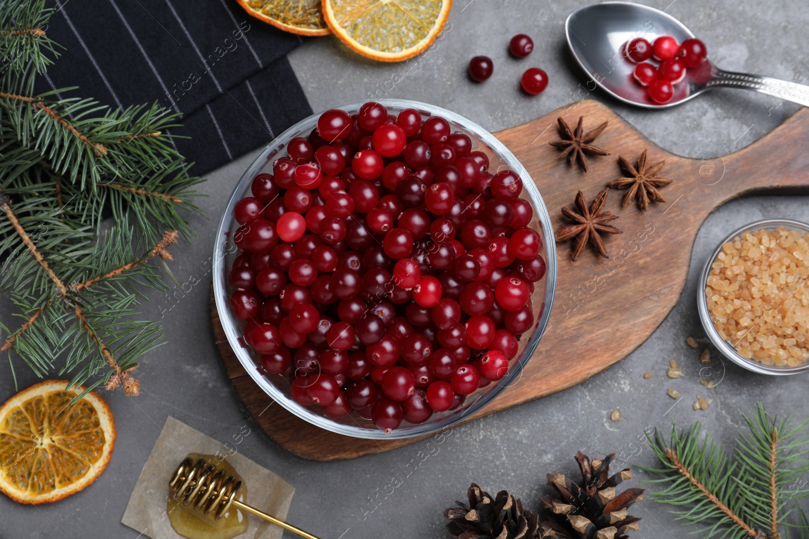 Photo of Flat lay composition with fresh ripe cranberries on grey table