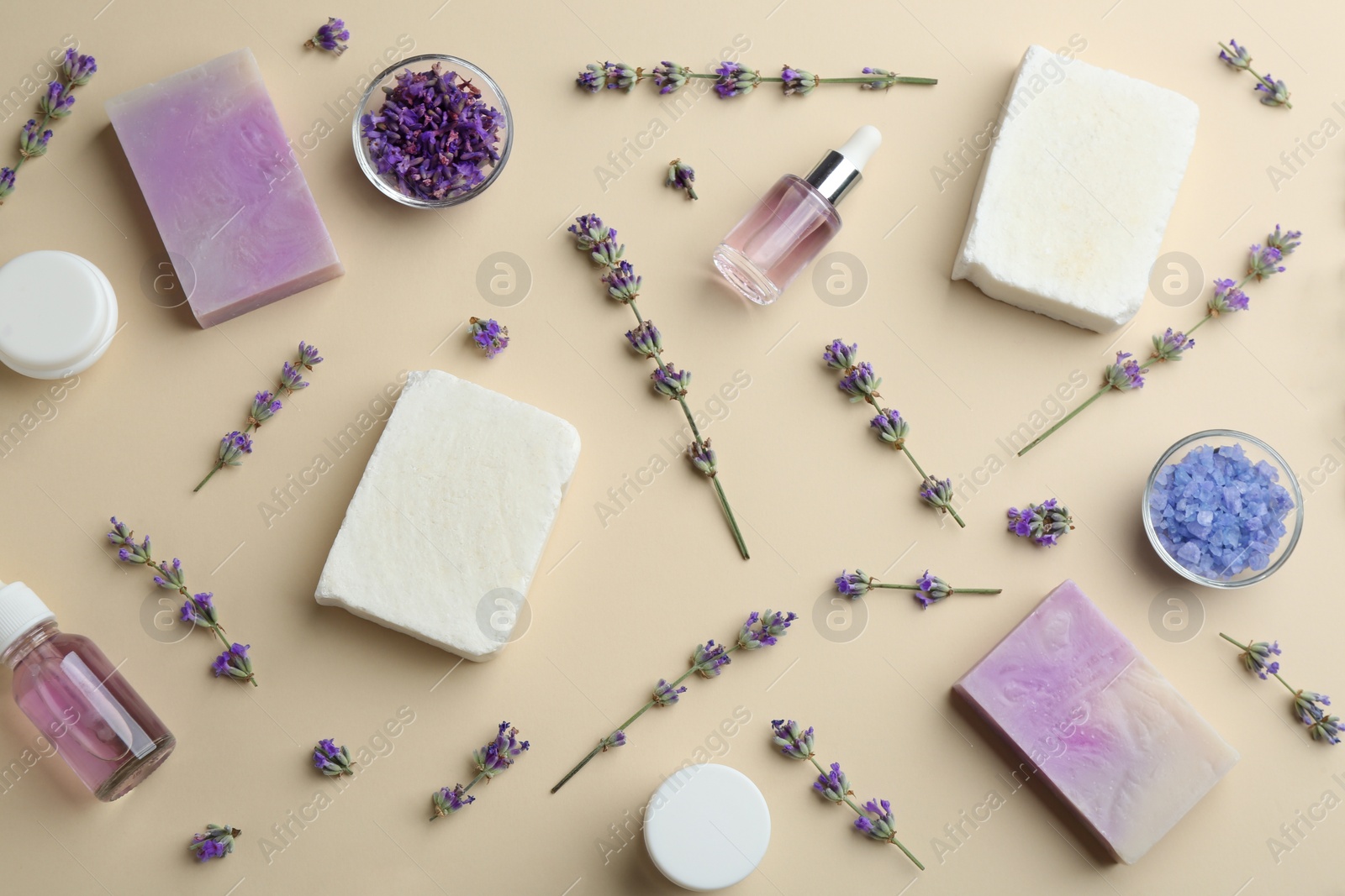 Photo of Flat lay composition of handmade soap bars with lavender flowers and ingredients on beige background